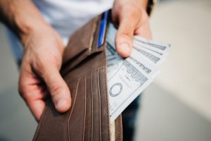 man taking cash out of his wallet